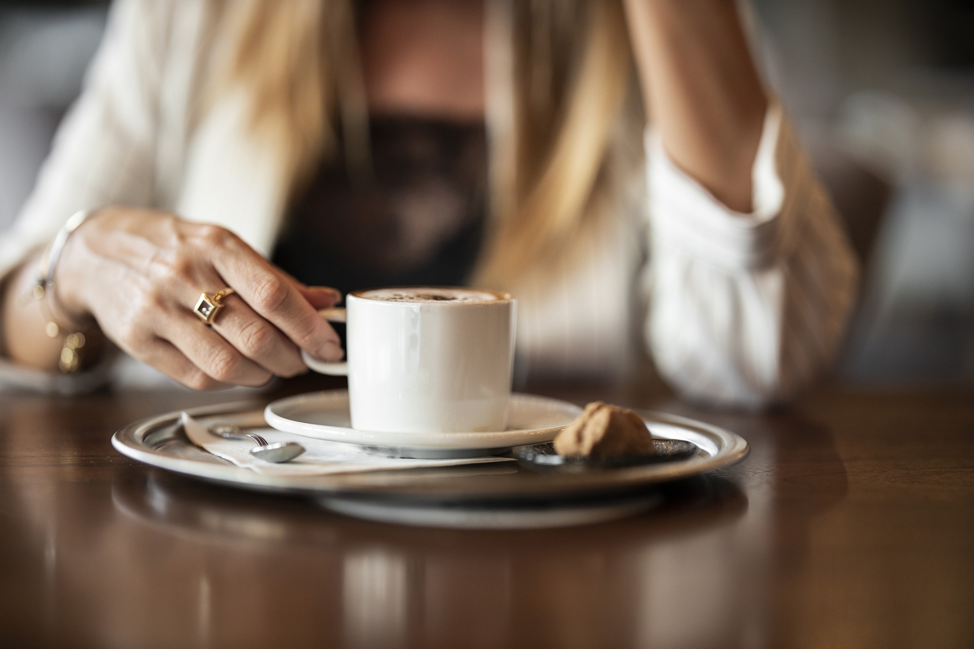 Photo of a woman holding a coffee