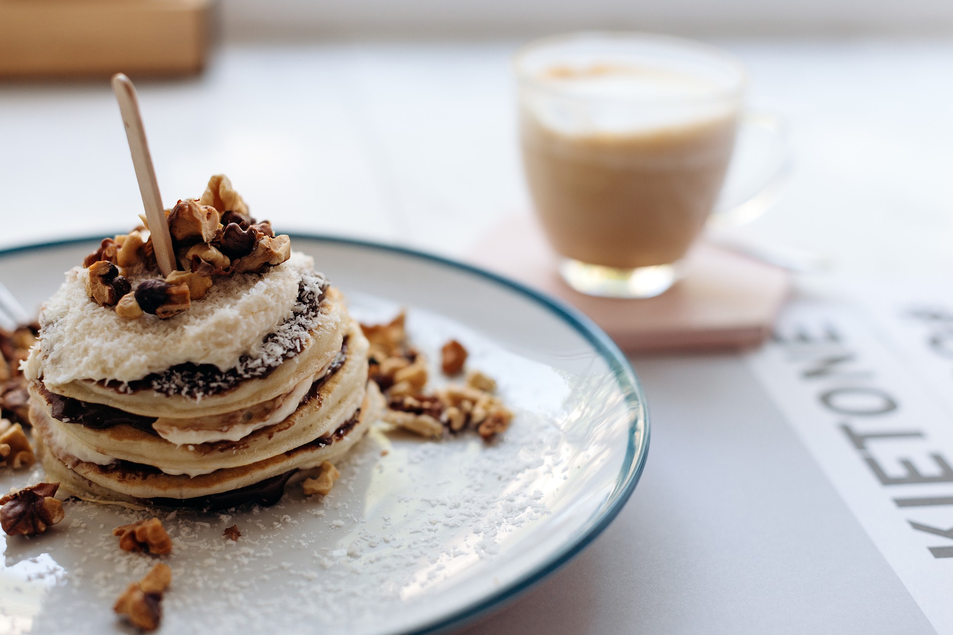 Photo of pancakes covered with walnuts and icing